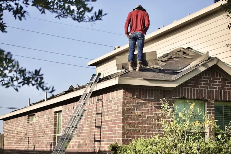 Professional roofer working on a residential roof in Lee Boulevard Heights